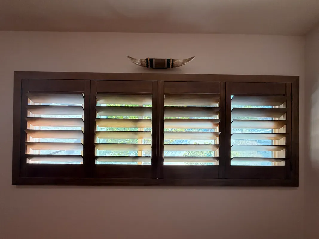 Hardwood plantation shutters with custom stain in Southern California home — natural wood window treatment